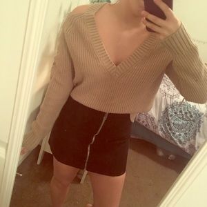 A tan v neck cut out sweater.